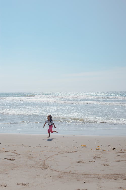 A little girl running on the beach