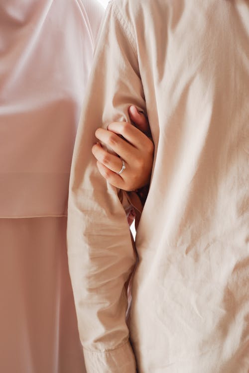 Woman Wearing Engagement Ring Holding Man Arm