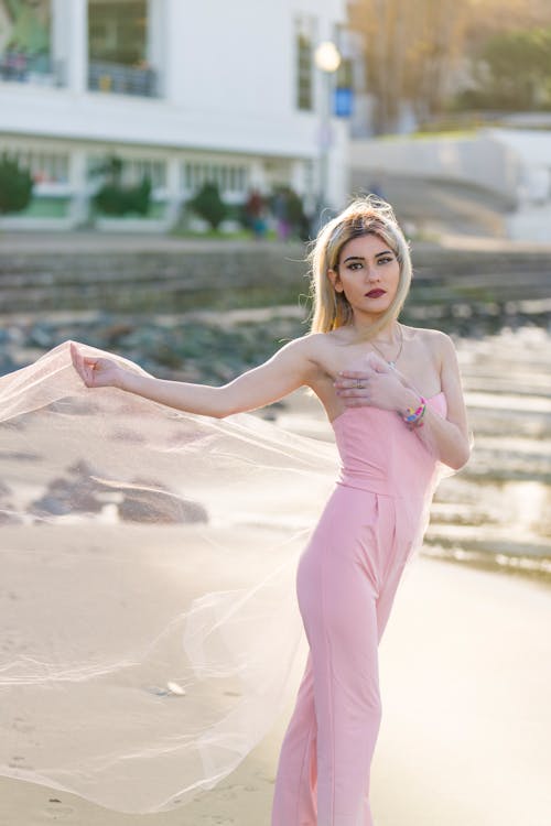 Blonde Woman in Pink Clothes on Beach