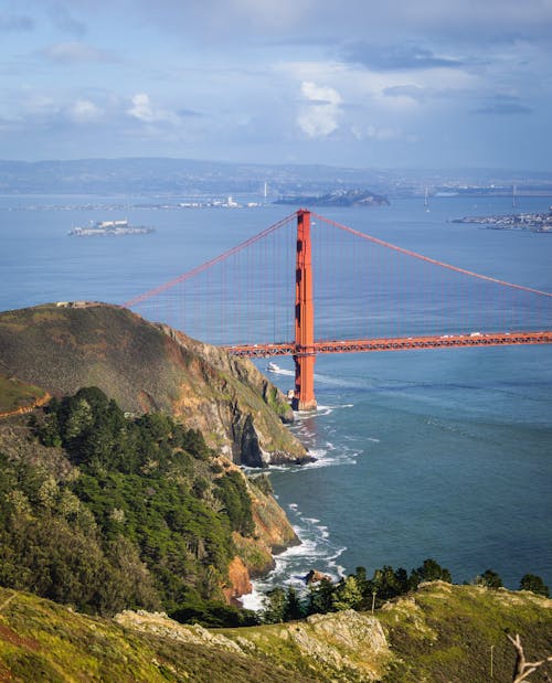 The golden gate bridge is seen from a hill