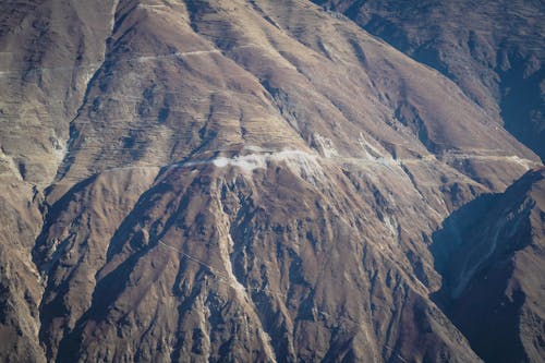An aerial view of a mountain range with a road