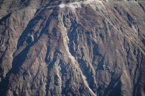 An aerial view of a mountain range with snow