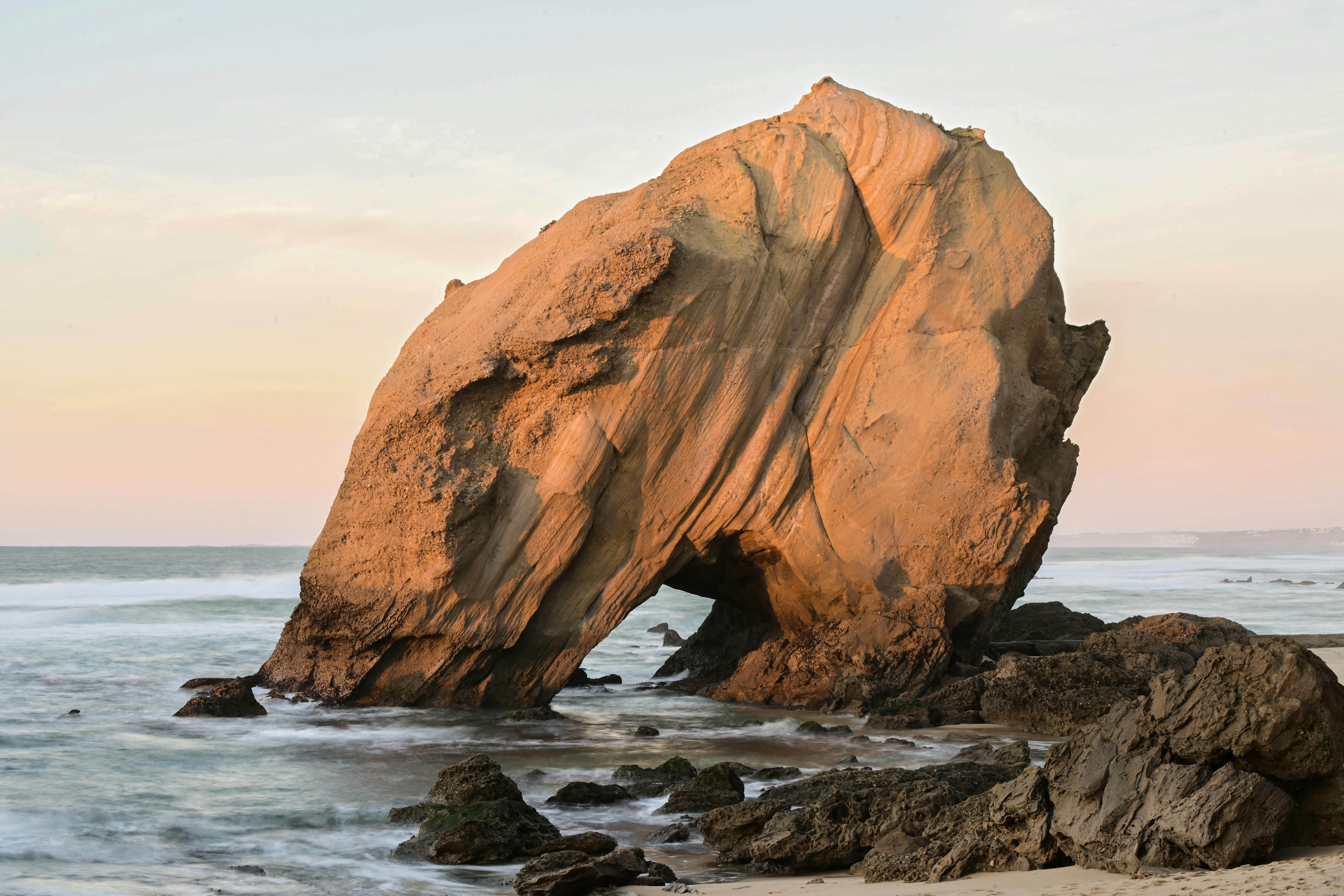 natural rock arch on santa cruz beach in portugal