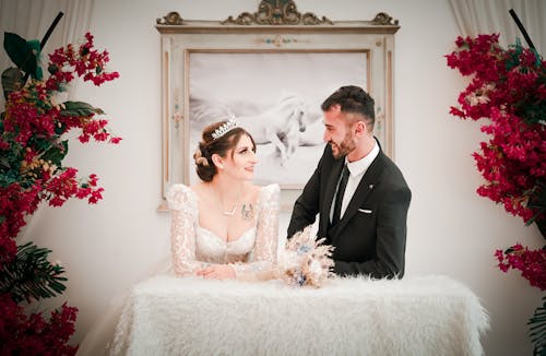 Smiling Couple Lean on Table