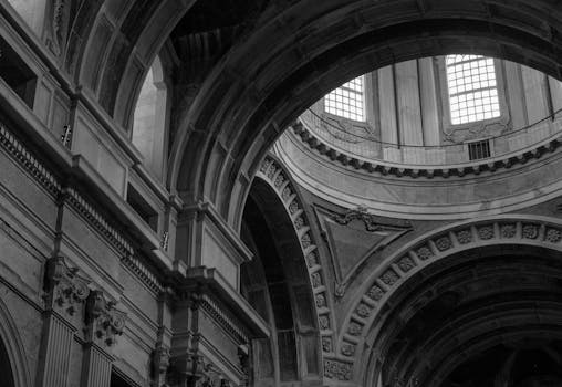 Explore the detailed baroque design of Mafra Palace's ceiling in Portugal.