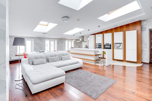 Free Bright open-plan living room with modern kitchen and skylights. Stock Photo