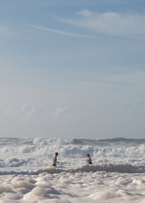 Couple among Waves on Sea Shore