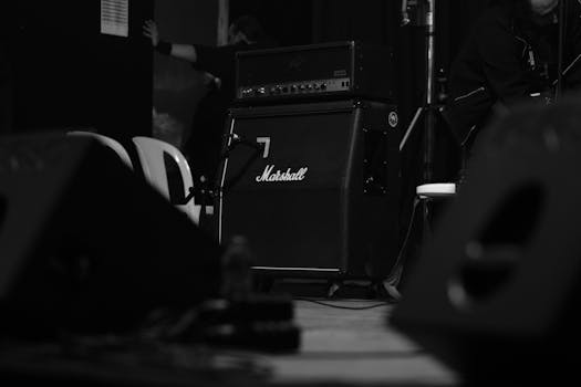 Black and white photo of a Marshall amplifier on stage, perfect for music and concert themes.