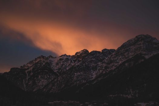 Stunning silhouette of rugged mountains beneath a vibrant sunset sky.