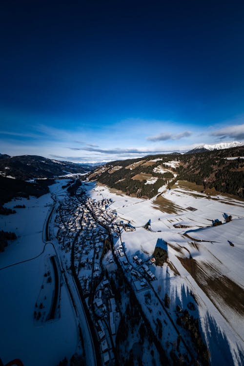 Aerial view of a snowy village in the mountains