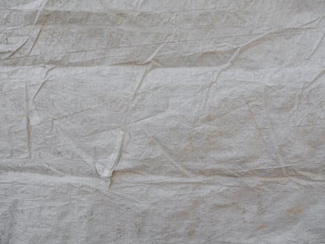 Detailed close-up of a white wrinkled paper texture offering a unique abstract background.