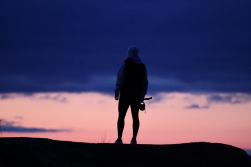 Silhouette of Man Standing under Cloud