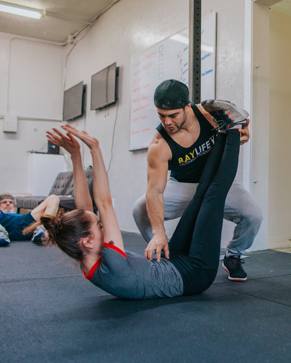 Free man touching woman on her belly while lying on floor stock photo