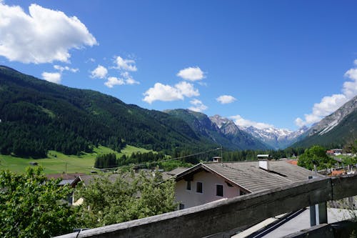A view of the mountains and houses from a balcony