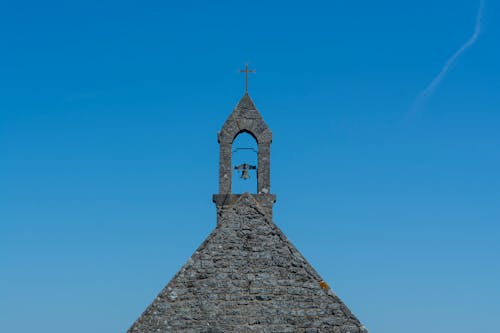 A church with a bell tower and a cross on top