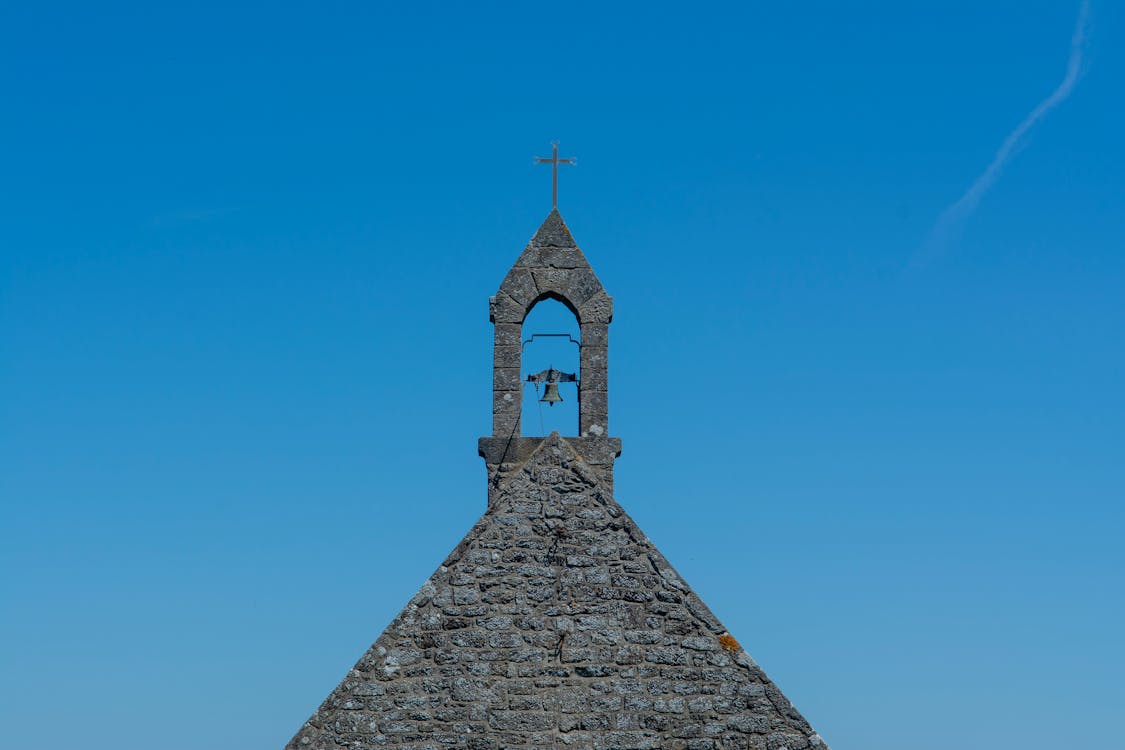 Close-up of a Bell Tower of an Old Stone Church 