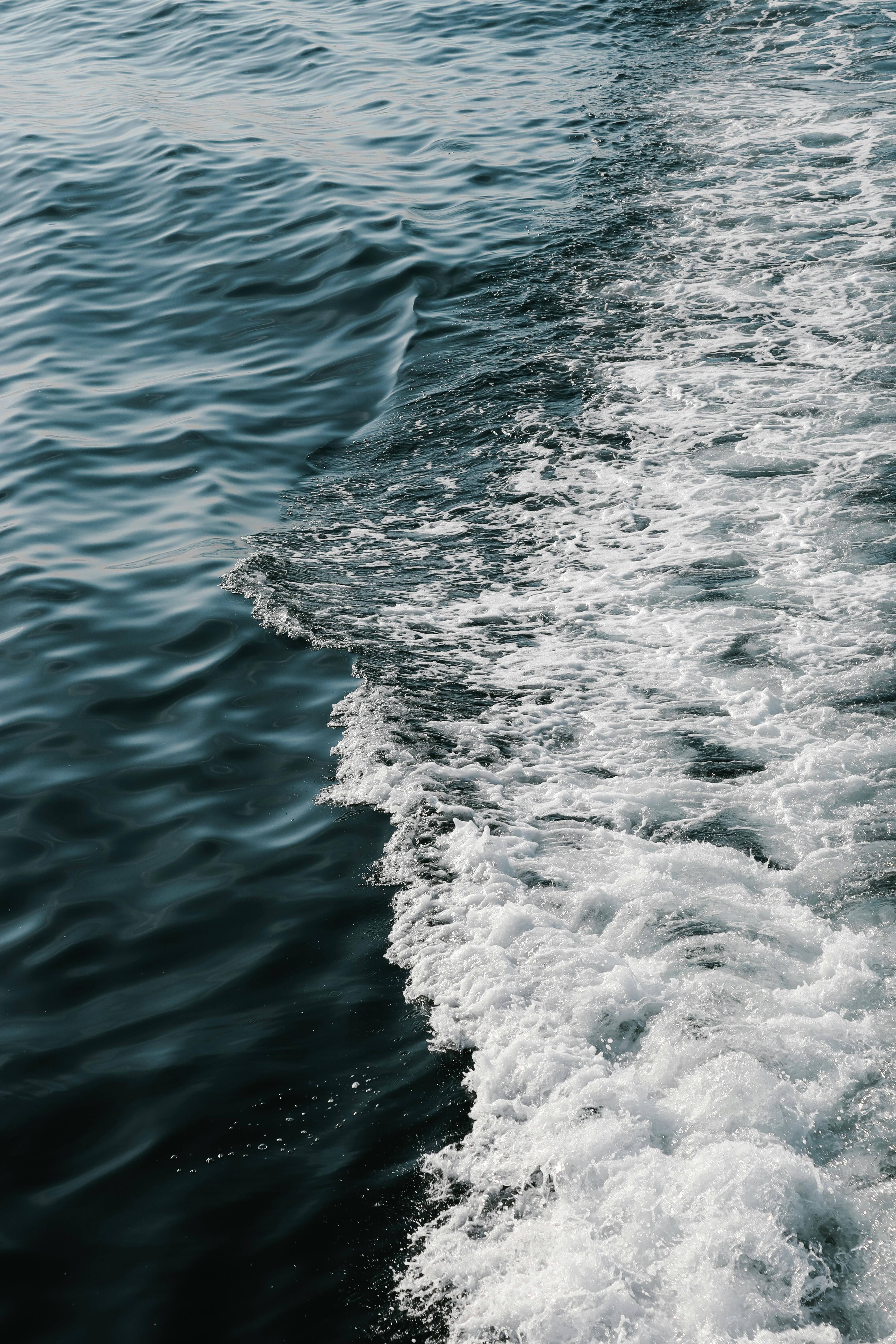 A stunning capture of ocean waves blending in a mesmerizing pattern, showcasing the power and beauty of nature.