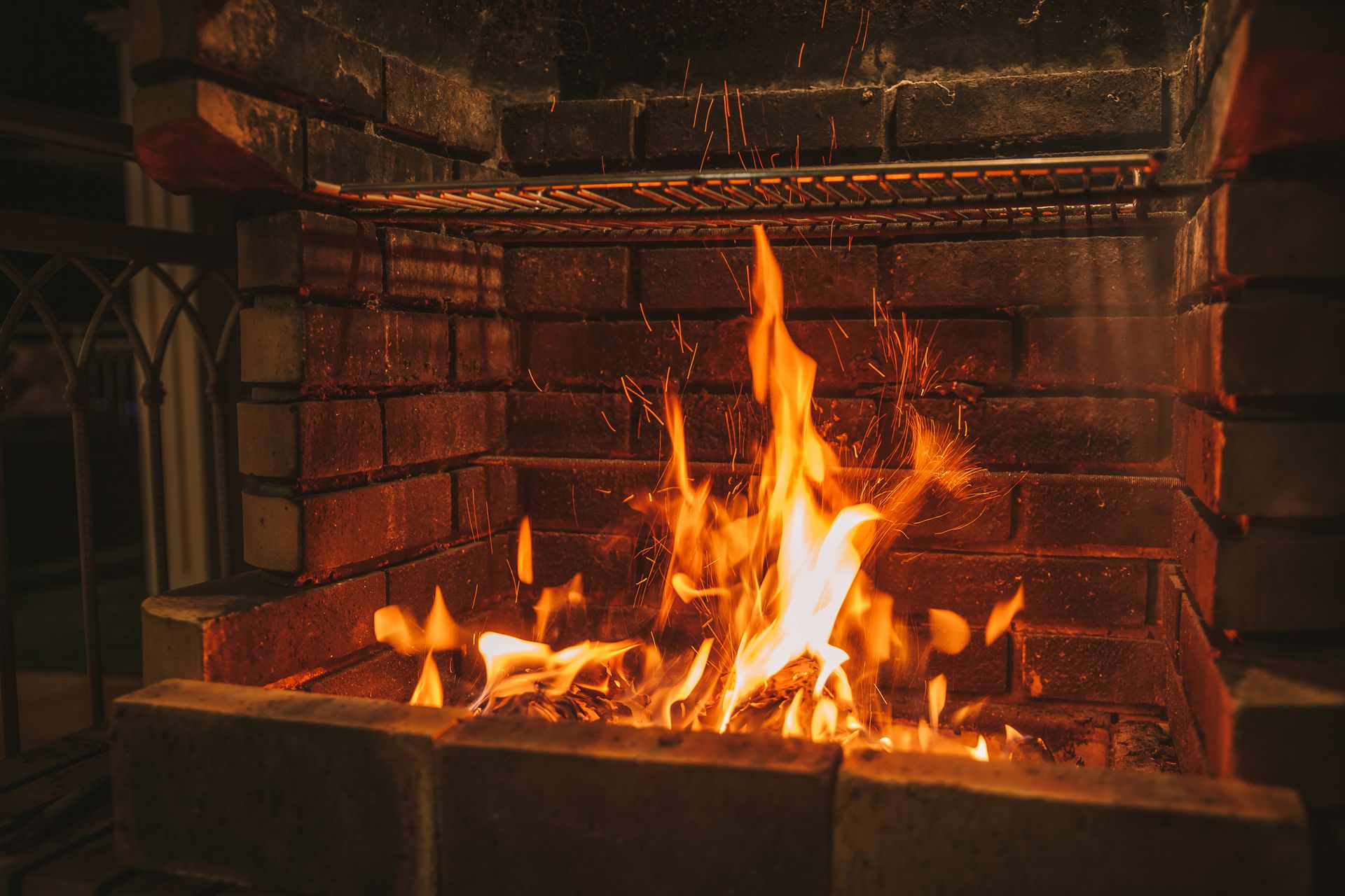 Warm and inviting brick fireplace with vibrant flames in a cozy setting.