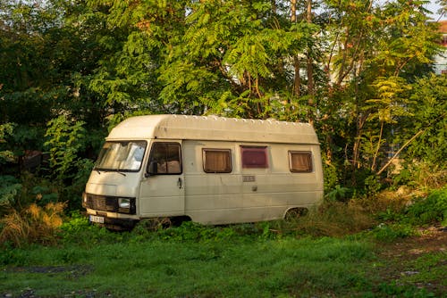 An old camper van parked in the grass
