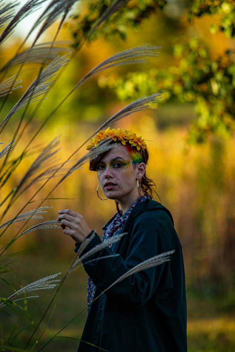 Portrait Of Woman With Colorful Makeup In A Forest 