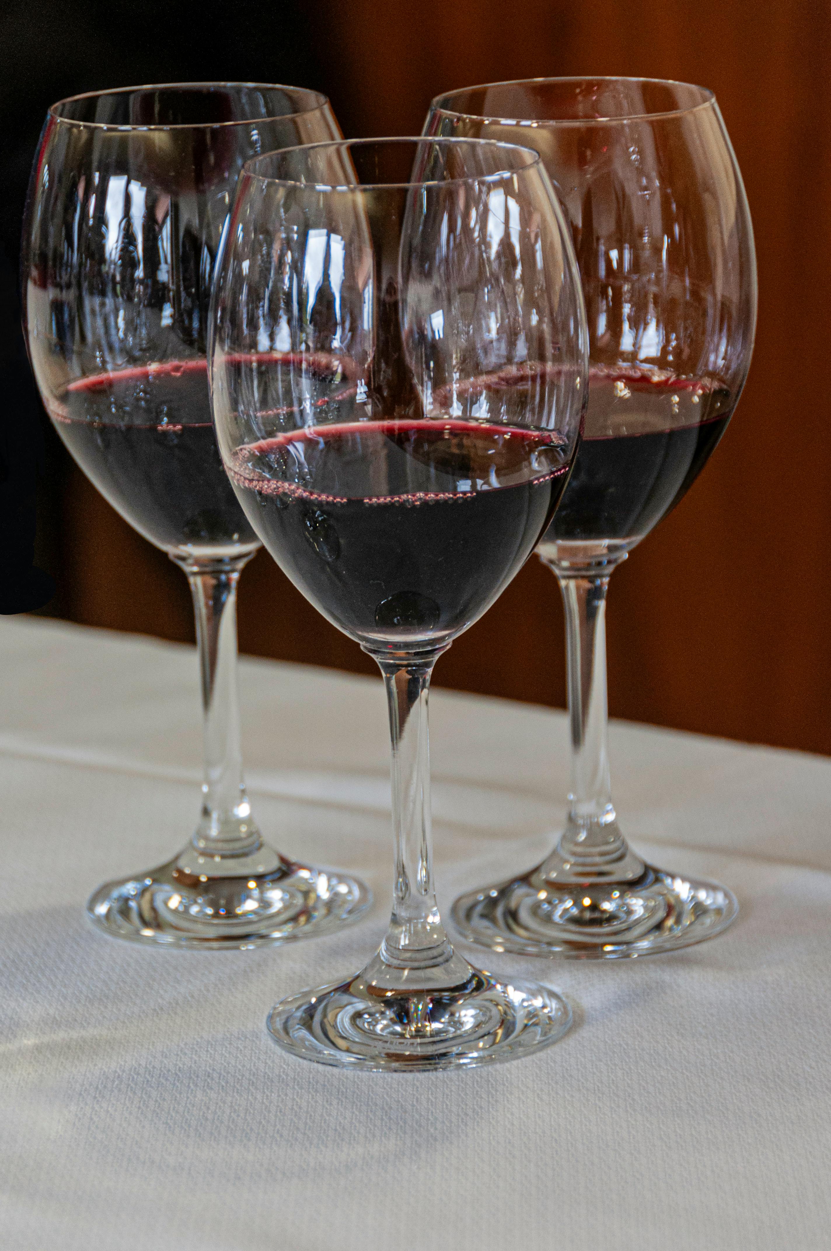 close up of glasses of red wine