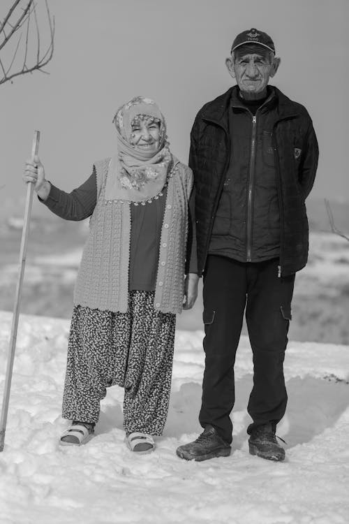 A man and woman standing in the snow