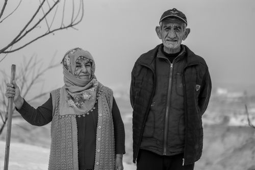 Free Elderly couple standing outdoors in a rural winter setting, showcasing rustic charm. Stock Photo