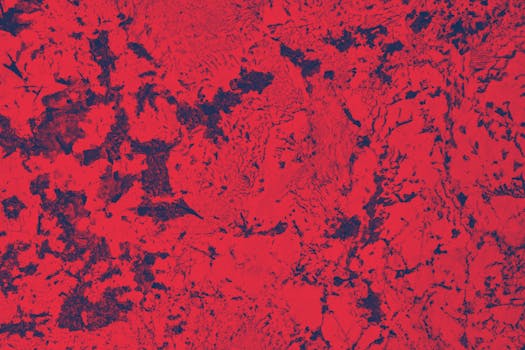 Vibrant red and black abstract texture with a rough, artistic design.