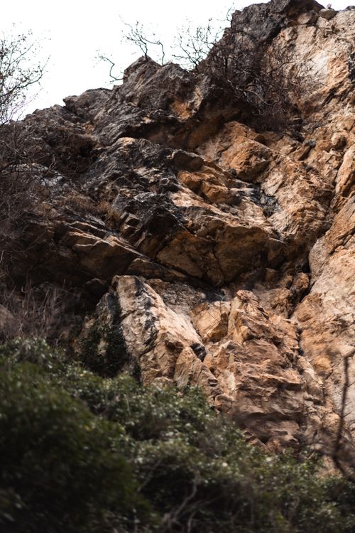 Free A detailed view of a rugged cliff face showcasing natural rock formations and textures. Stock Photo