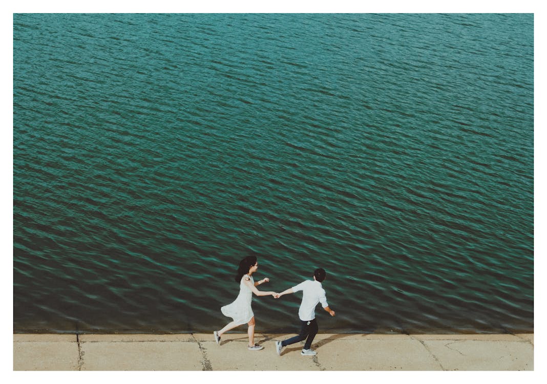 Man and Woman Running on Dockside