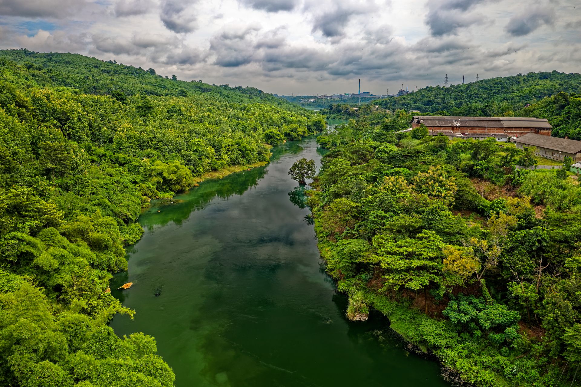 Aerial view of lush green landscape and river in Purwakarta, Indonesia.