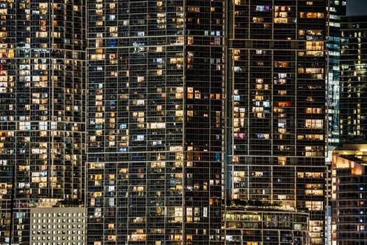 A captivating view of illuminated skyscrapers in a bustling city at night.