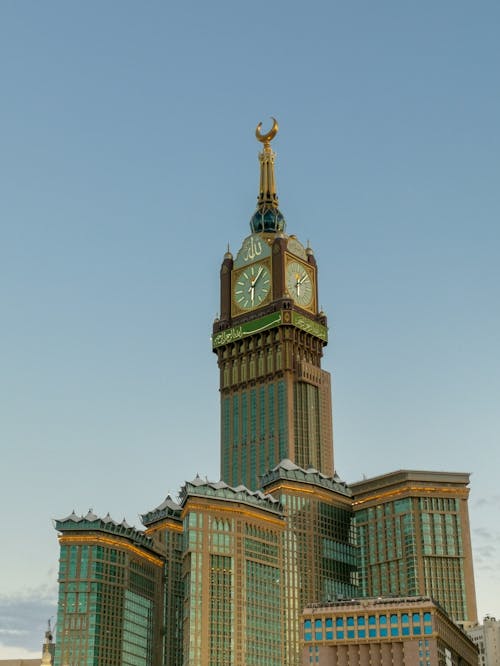 A large clock tower in front of a building