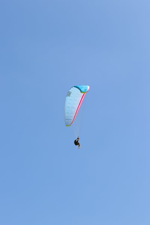 Free Experience the thrill of paragliding over Varkala, India with clear blue skies and breathtaking views. Stock Photo