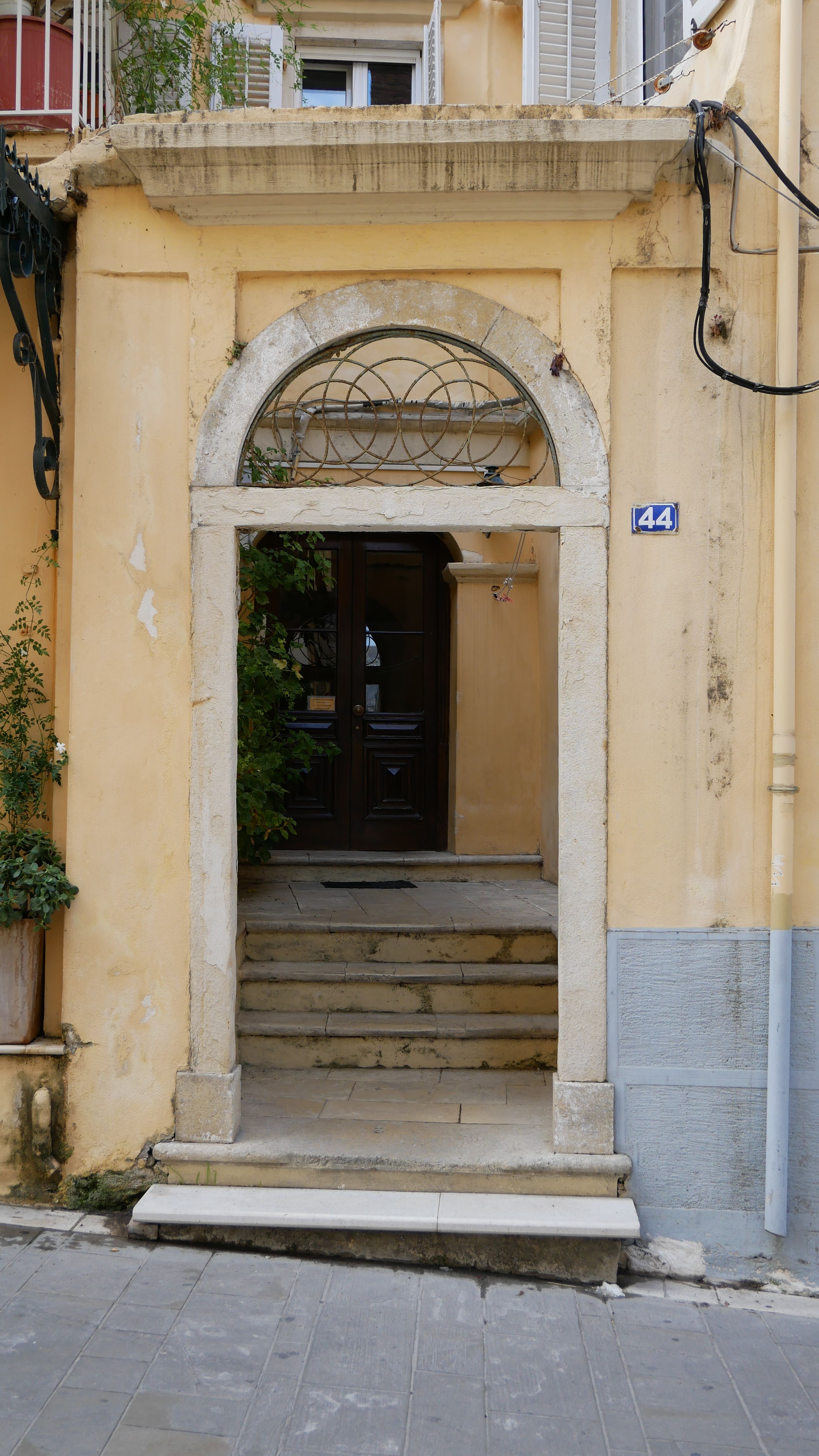 Charming old-world entrance with stone steps and archway, perfect for architectural themes.