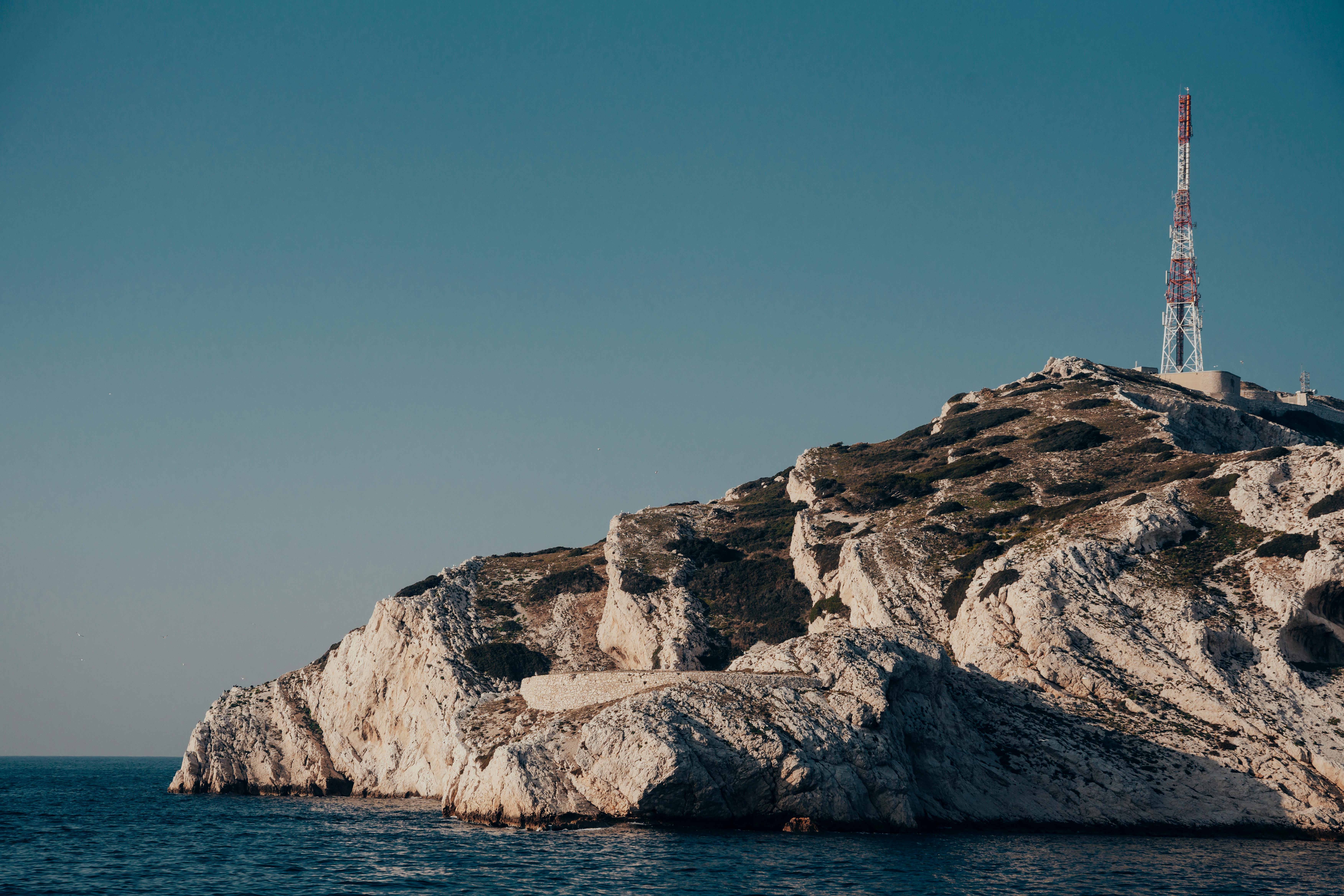 Radio Tower on a Rocky Hill by the Sea · Free Stock Photo