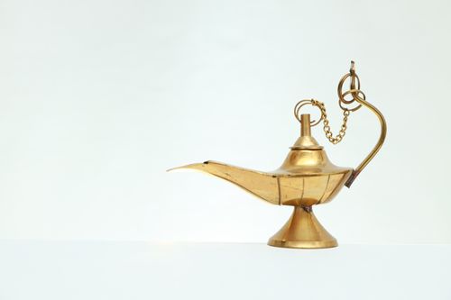Free Elegant golden brass genie lamp isolated on a white backdrop, capturing timeless mystique. Stock Photo