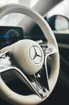 Close-up of a luxury car's steering wheel showcasing a sleek and modern design.