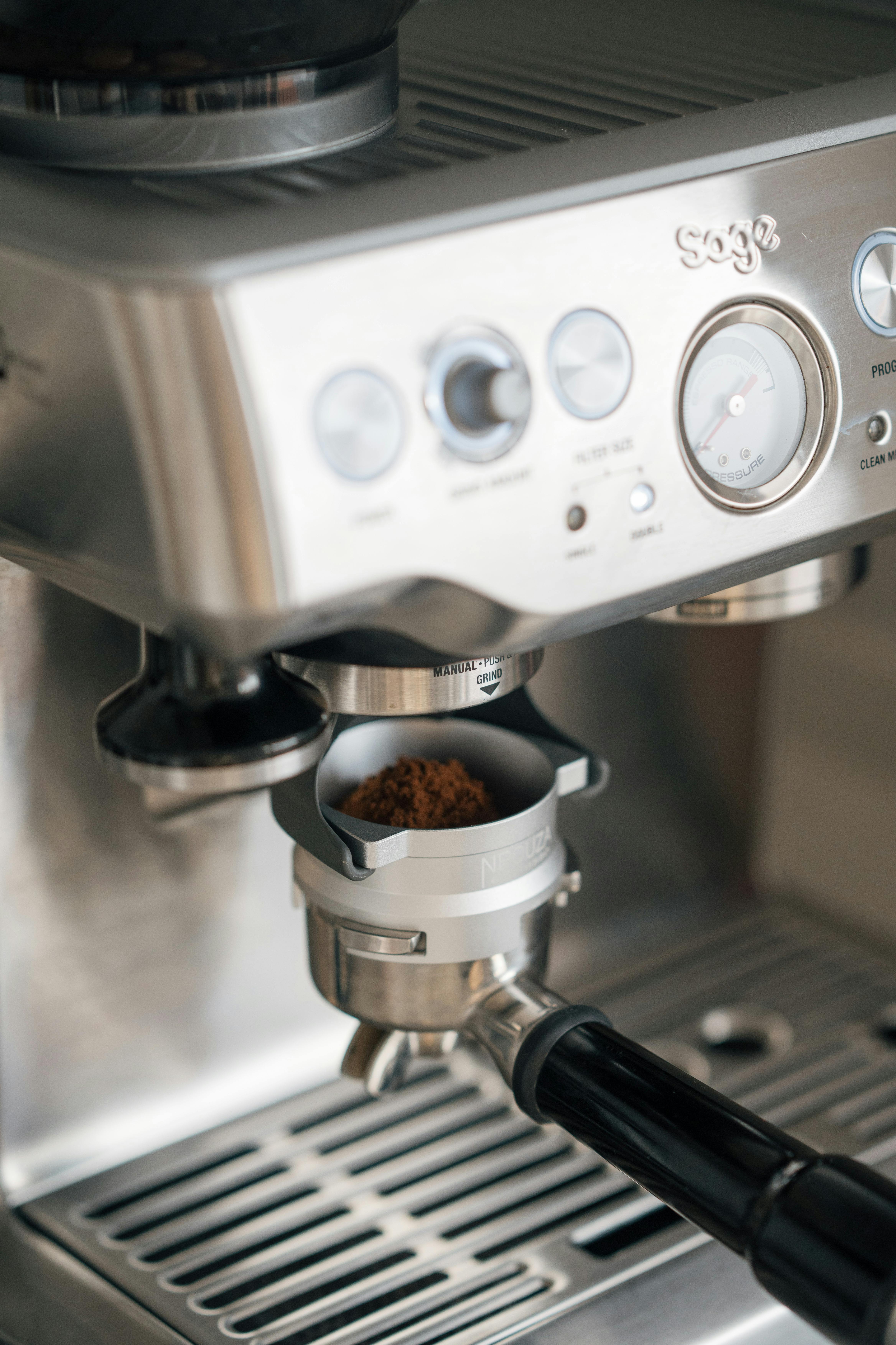 Close-up of a coffee machine grinding beans in a kitchen setting.
