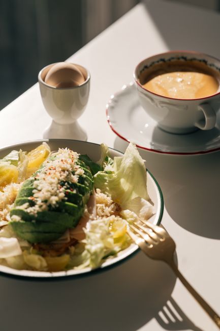 Appetizing breakfast setup featuring an avocado salad with coffee, perfect for a nutritious morning meal.