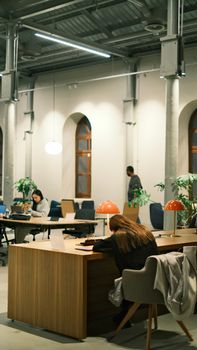 Modern office interior with people working and collaborating in a shared space.