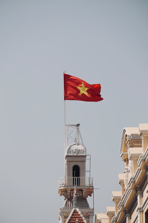 A vietnamese flag flying on top of a building