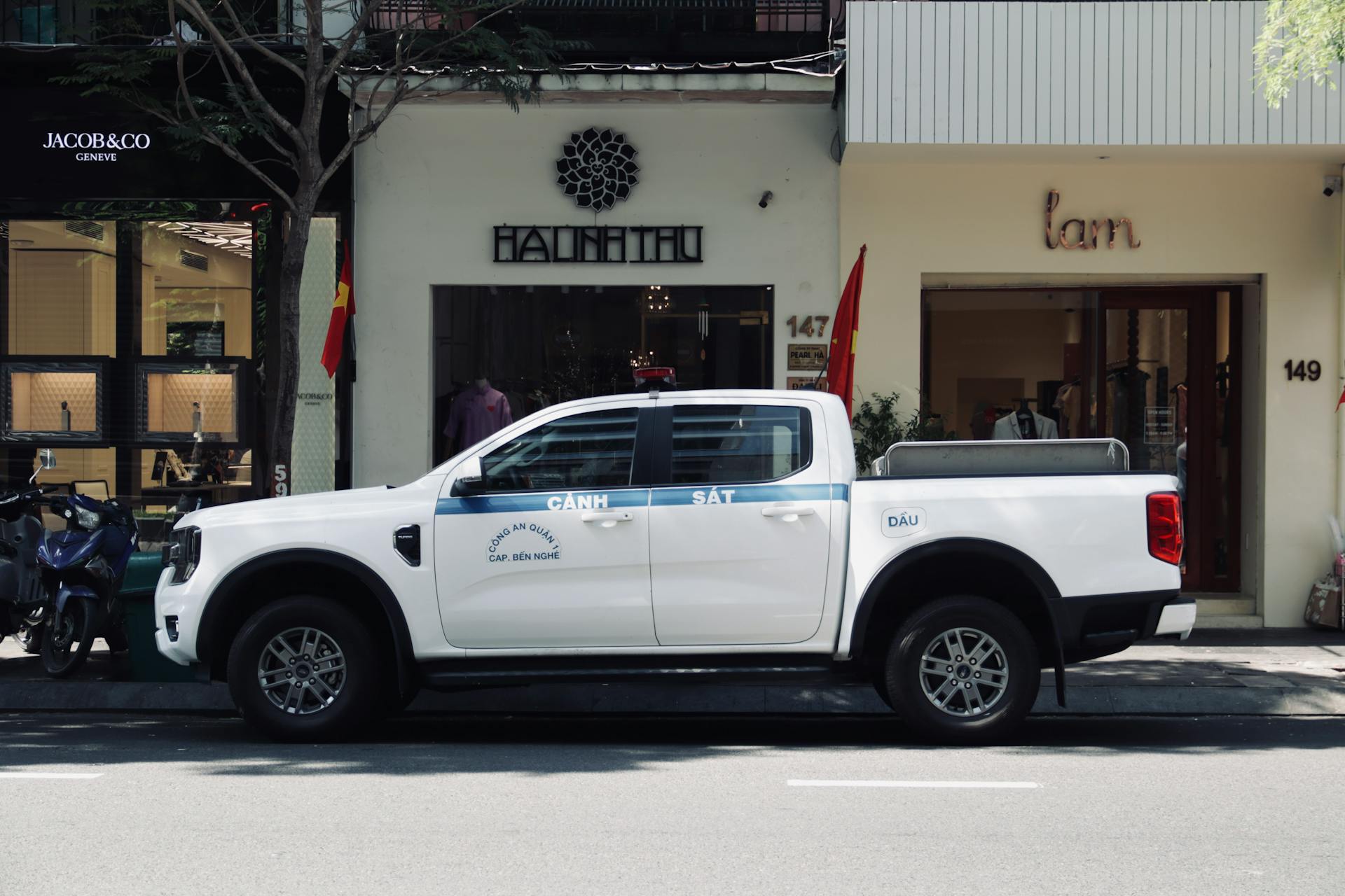 Ford pickup truck parked on a street in Vietnam, showcasing urban life.