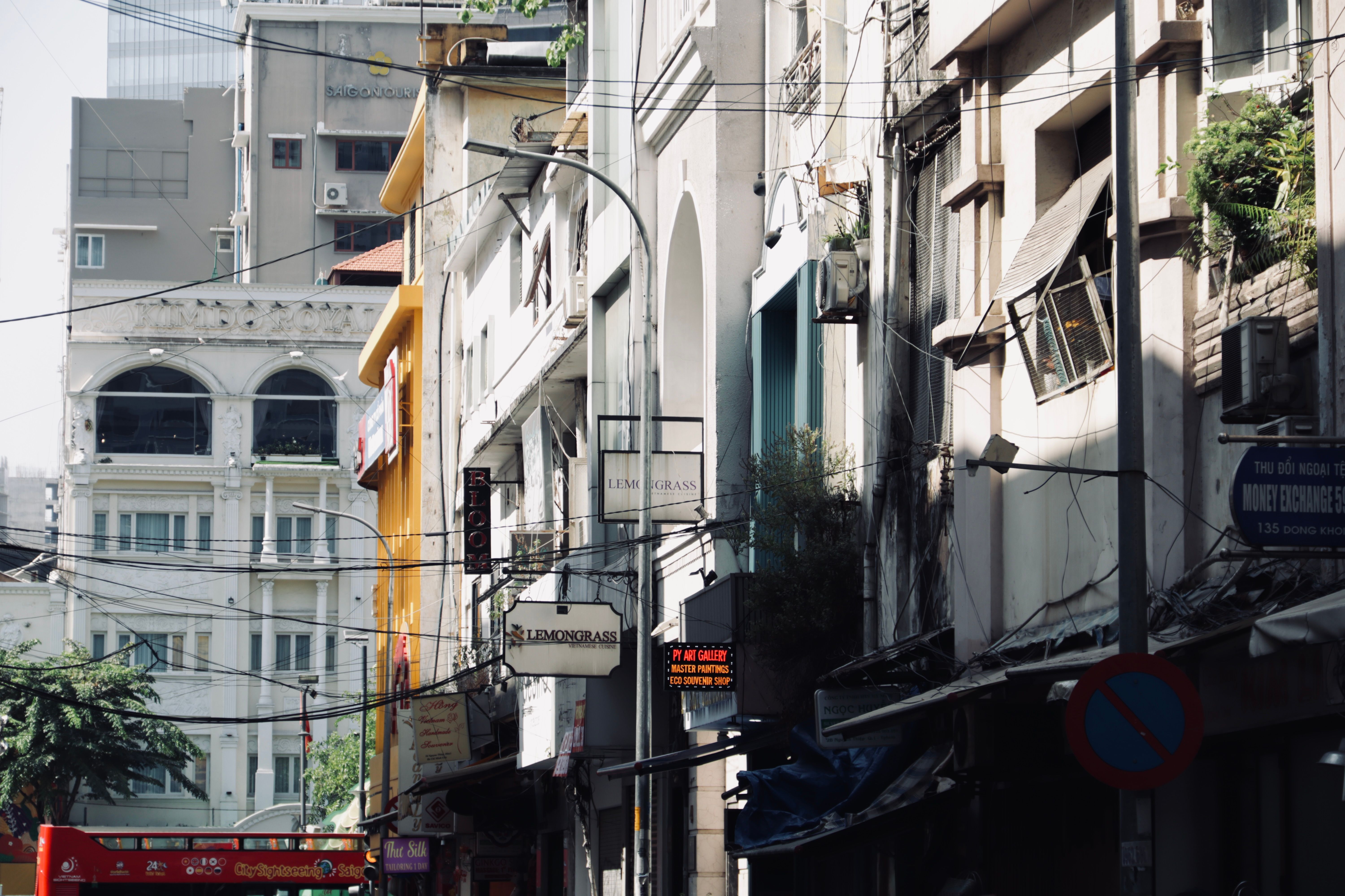 Bustling urban street lined with historical buildings in daylight.