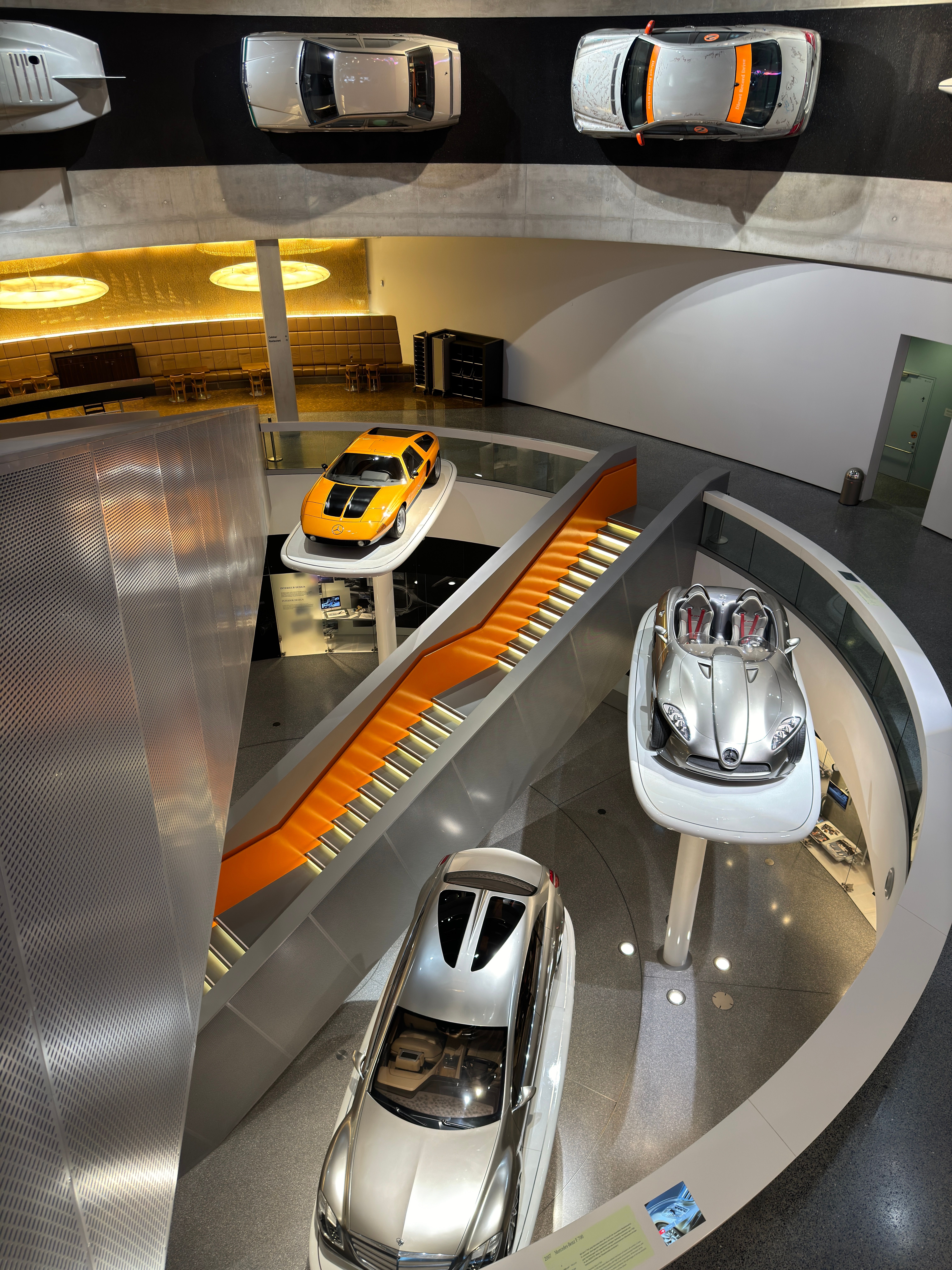Explore the dynamic interior of the Mercedes-Benz Museum showcasing classic and modern cars.