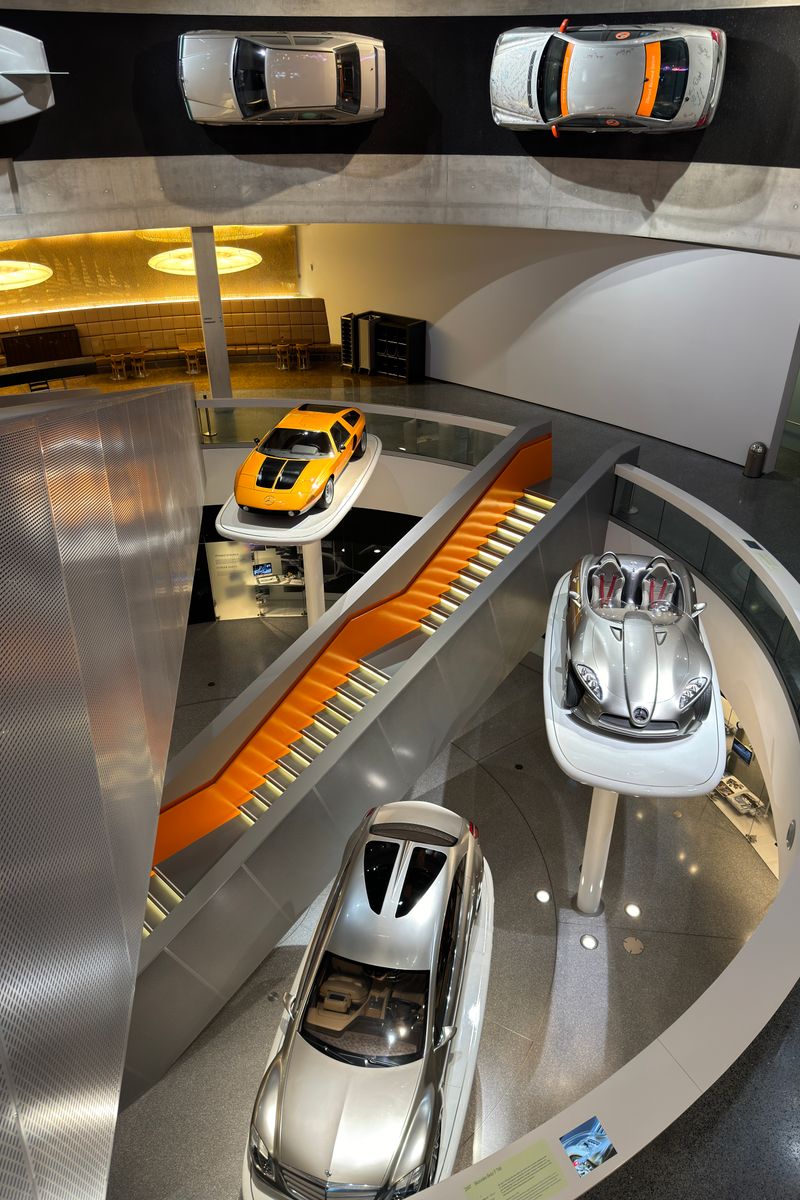 Explore the dynamic interior of the Mercedes-Benz Museum showcasing classic and modern cars.