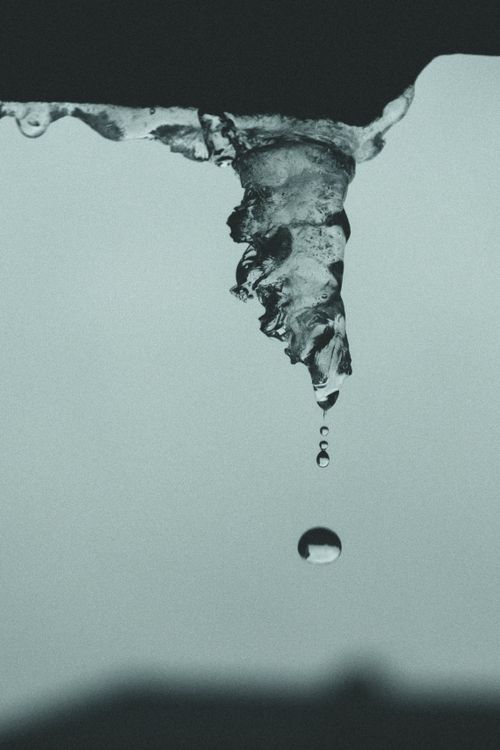 Free Detailed image of a melting icicle dripping water, symbolizing the seasonal transition. Stock Photo