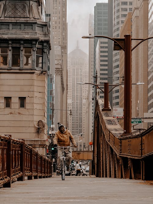 A man riding a bike on a bridge in chicago