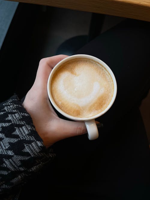 Free A Person Holding a Cup of Coffee Stock Photo