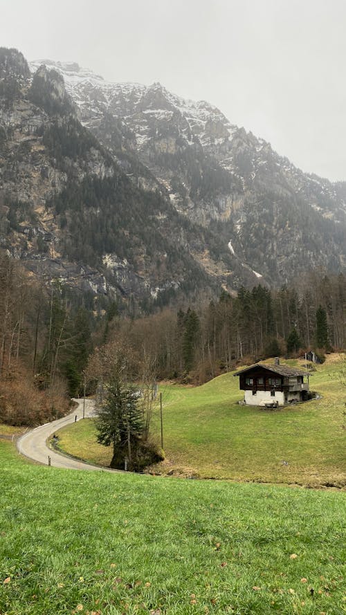 Free Cottage and a Road in the Mountains  Stock Photo